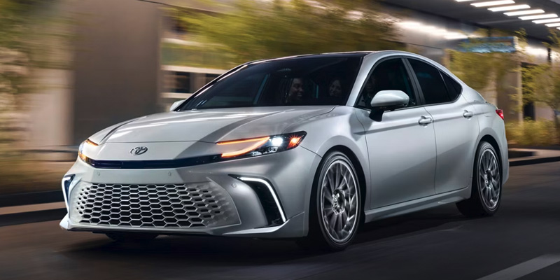 2024 Toyota Camry driving at night in urban setting