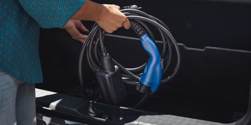 EV charging cable connected to a vehicle showcasing electric vehicle charging technology.